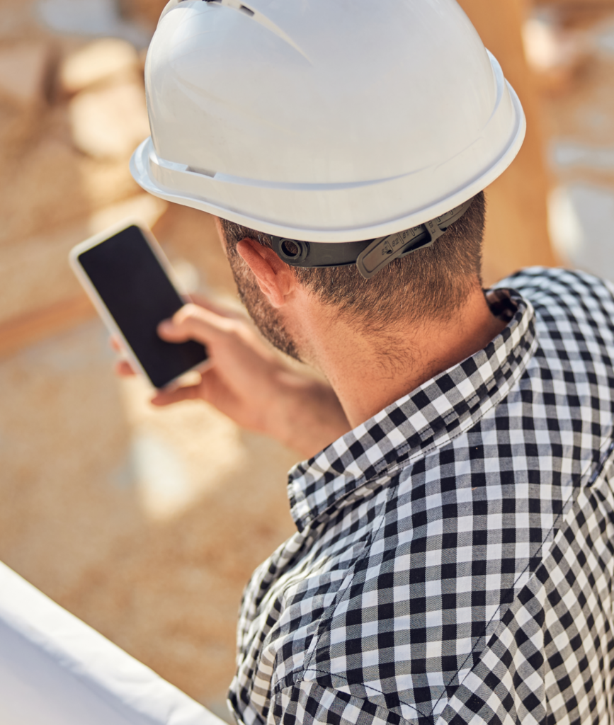 construction worker checking phone